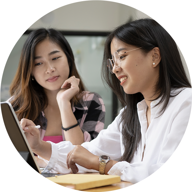 Two Asian girls looking at a laptop
