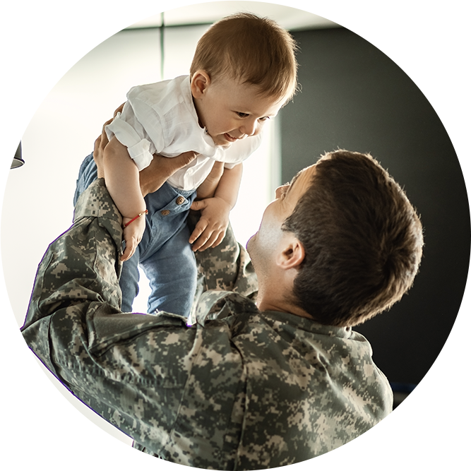 Military man holding child